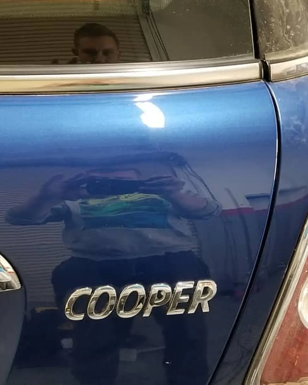 After: Dent in the tailgate of a Mini Cooper