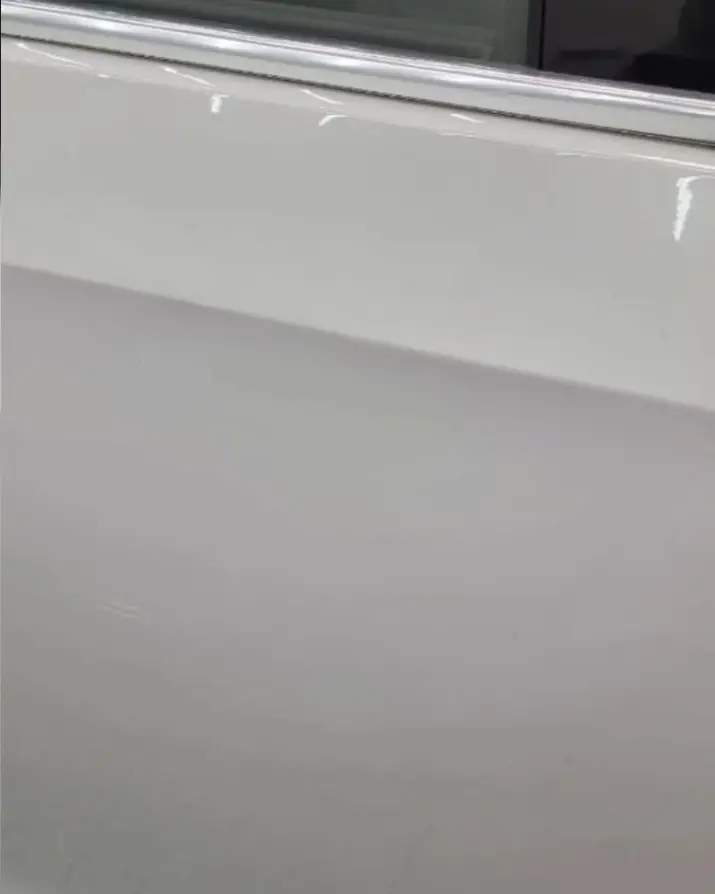 After: Dent low on a white door
