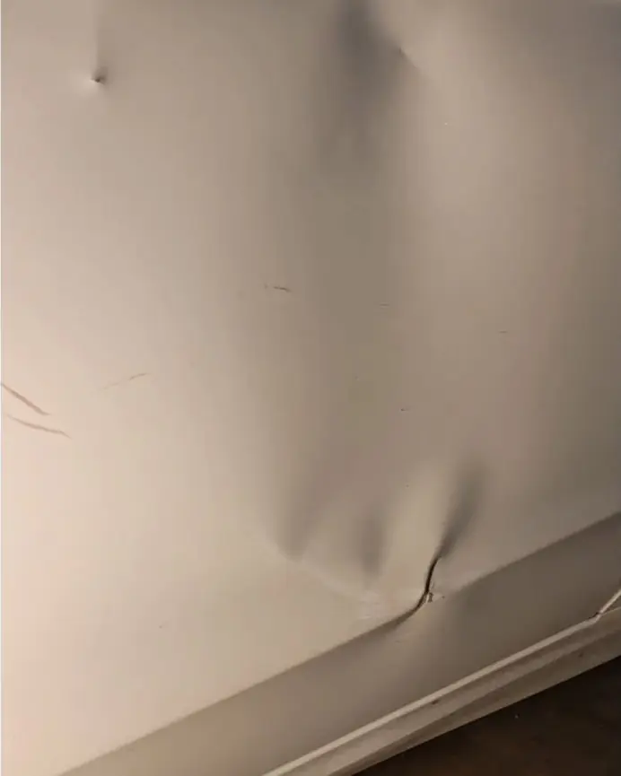 Before: Body-line crease on a white door